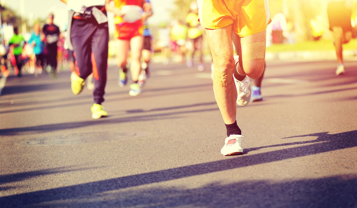 Marathon running race, people feet on city road